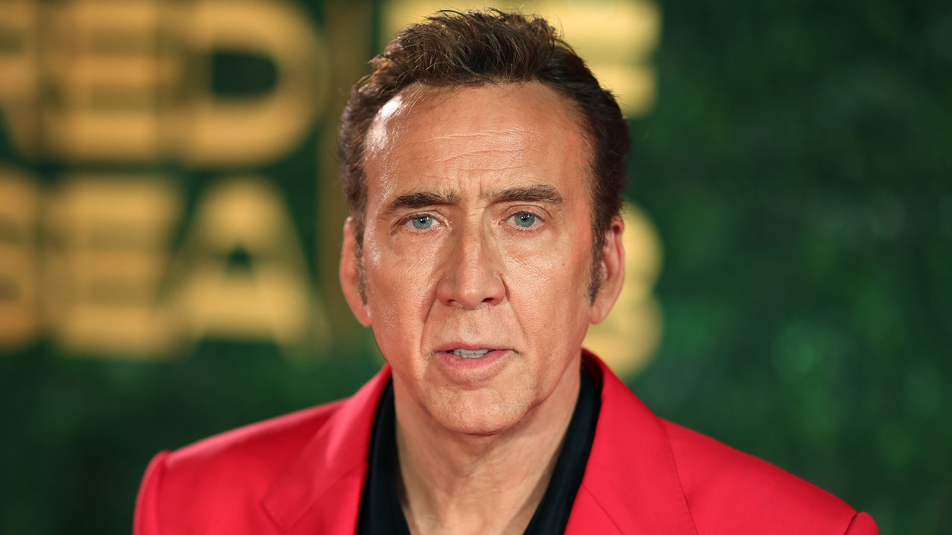 media-9c05f2b866cf-close-up-of-nicolas-cage-in-a-red-suit